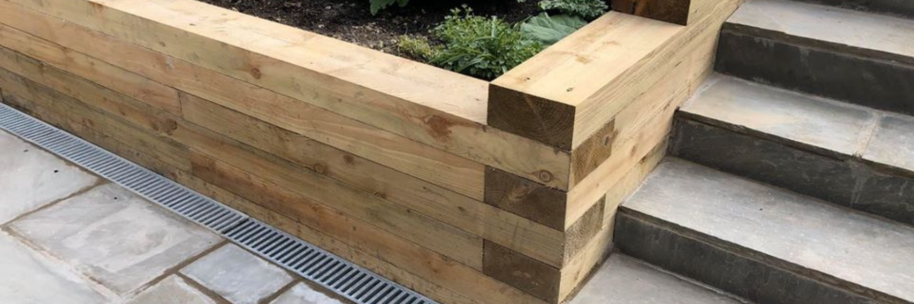 image of a raised bed using suregreen railway sleepers in someones garden