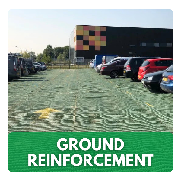Plastic ground reinforcement grids installed in a parking area with cars parked on top.